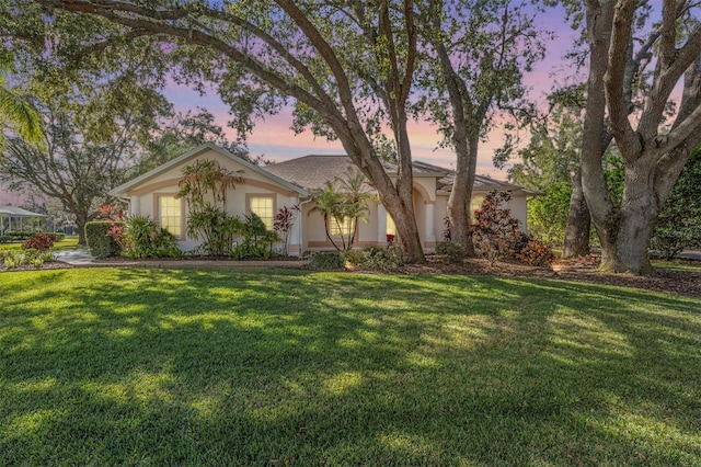 single story home with a yard