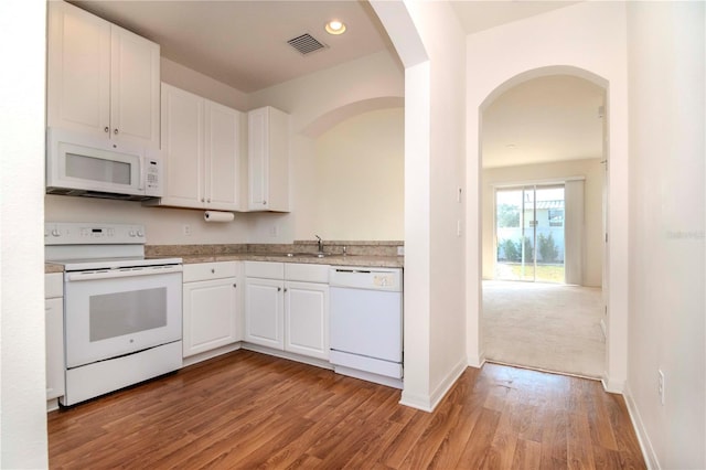 kitchen featuring white cabinets, light wood-type flooring, white appliances, and sink