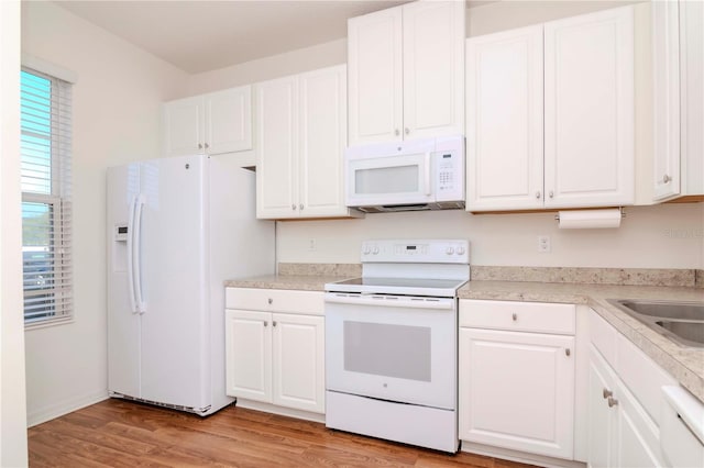 kitchen with white cabinets and white appliances