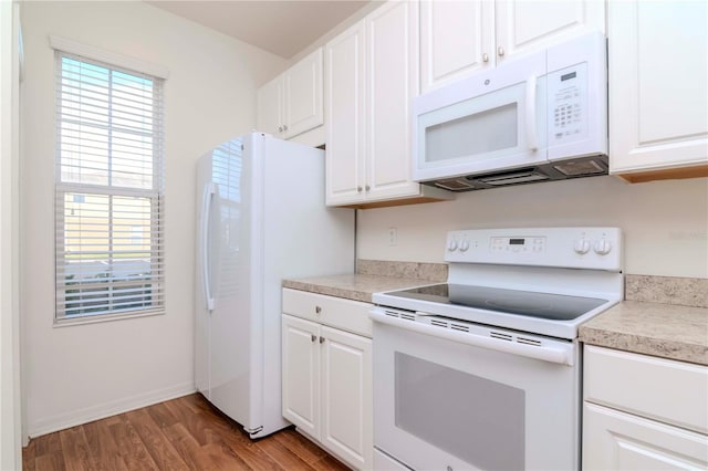 kitchen with white cabinetry, light hardwood / wood-style flooring, and white appliances