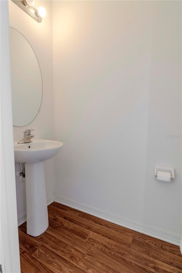 bathroom with hardwood / wood-style floors and sink