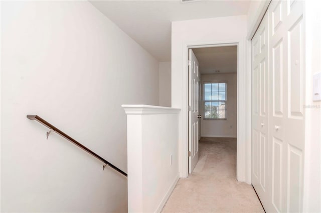 corridor with light colored carpet