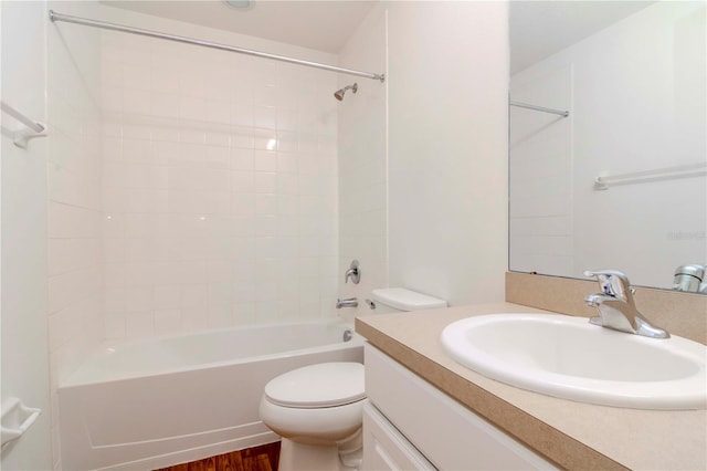 full bathroom with hardwood / wood-style floors, vanity, bathing tub / shower combination, and toilet