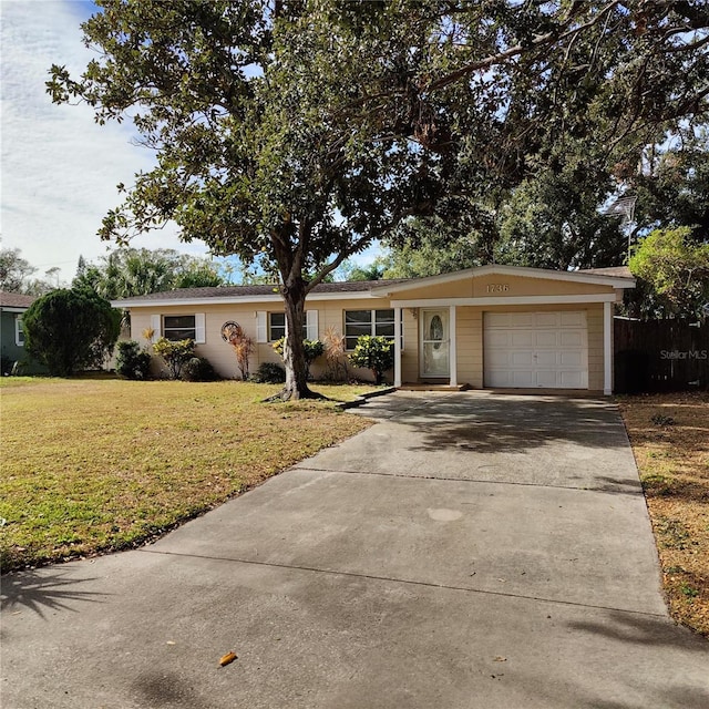 ranch-style house with a front yard and a garage