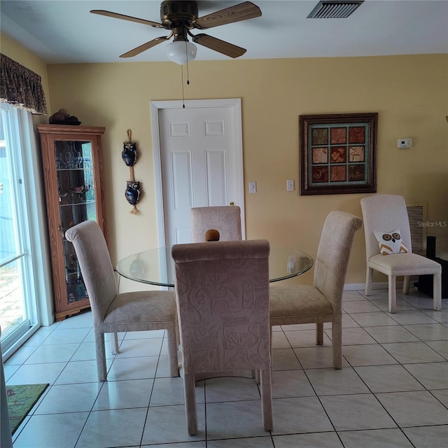 dining area with ceiling fan, light tile patterned floors, and a healthy amount of sunlight