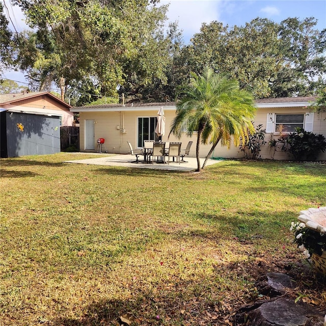 view of yard with a patio and a storage unit