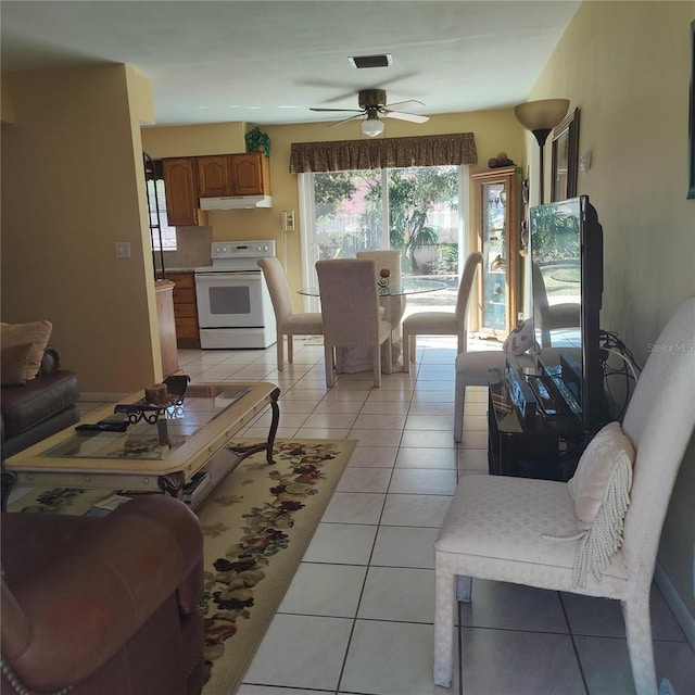 living room with ceiling fan and light tile patterned flooring