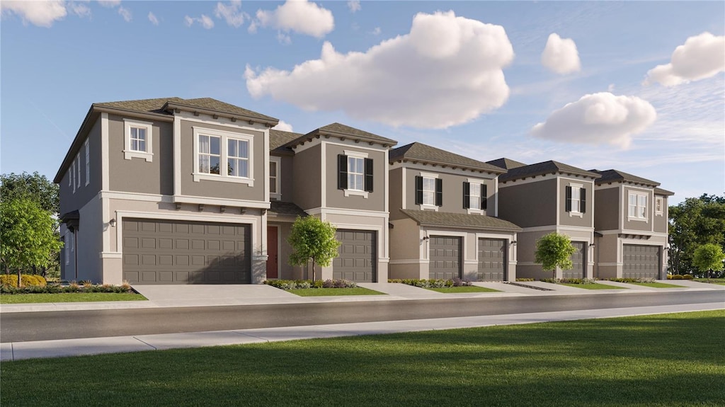 view of front of home with a front lawn and a garage