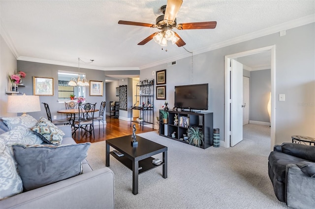 living room with a textured ceiling, ceiling fan with notable chandelier, carpet flooring, and crown molding