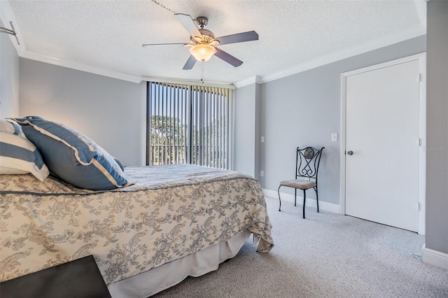 bedroom featuring ceiling fan, carpet, a textured ceiling, and ornamental molding