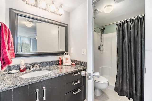 bathroom featuring ceiling fan, a shower with curtain, tile patterned flooring, toilet, and vanity