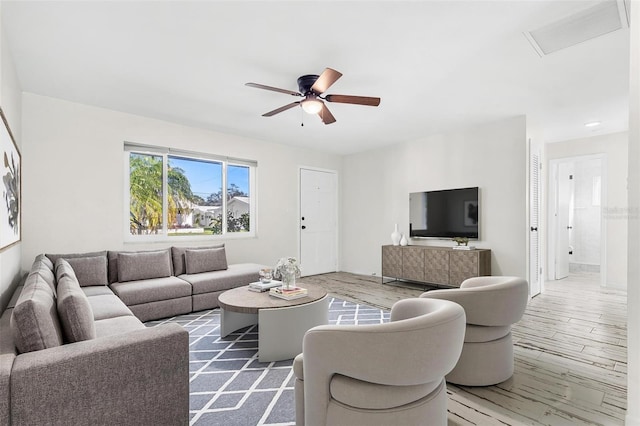 living room with ceiling fan and wood-type flooring