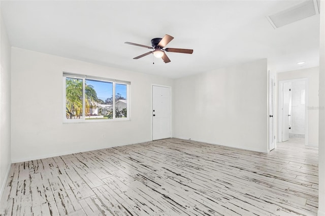 empty room featuring ceiling fan and light wood-type flooring