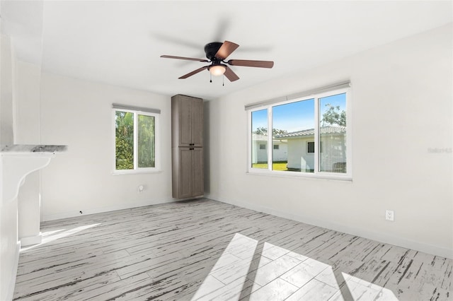 unfurnished room featuring ceiling fan and light wood-type flooring