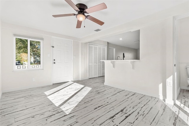 unfurnished room featuring ceiling fan and light hardwood / wood-style flooring