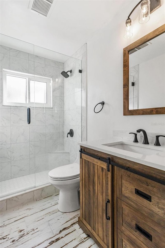 bathroom featuring vanity, toilet, and walk in shower