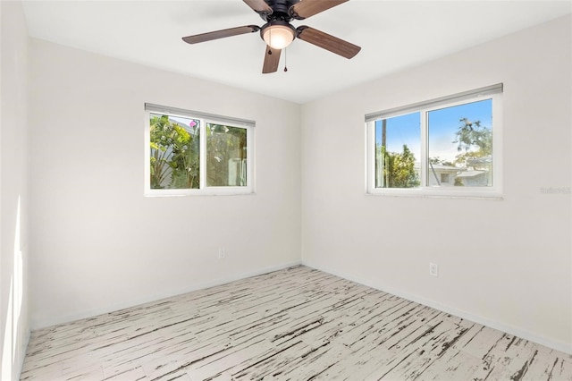 spare room with ceiling fan and light wood-type flooring