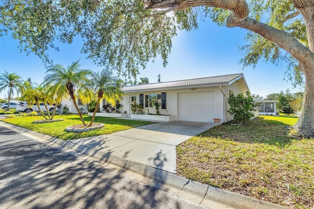 single story home with a garage and a front lawn