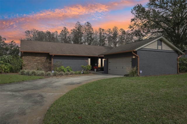 ranch-style home with a lawn and a garage