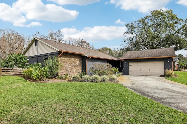 single story home featuring a garage and a front lawn