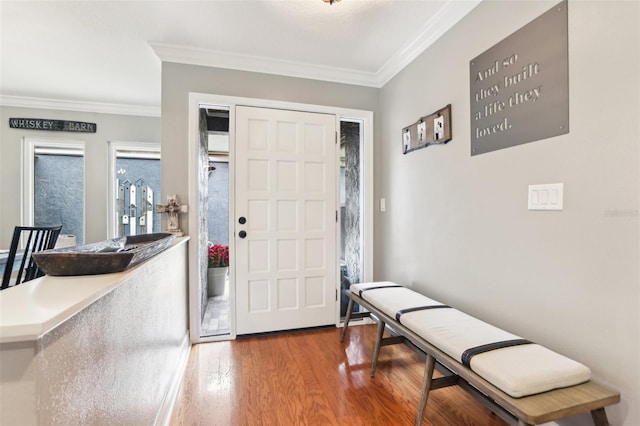 foyer with hardwood / wood-style flooring and crown molding