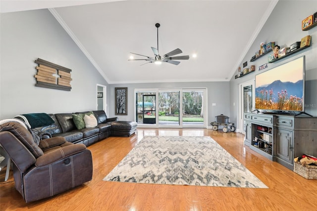 living room with ceiling fan, lofted ceiling, and ornamental molding