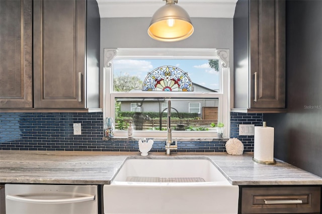 kitchen with dishwasher, decorative backsplash, dark brown cabinetry, and sink