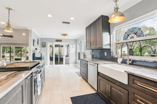 kitchen with backsplash, sink, ceiling fan, dark brown cabinetry, and stainless steel appliances