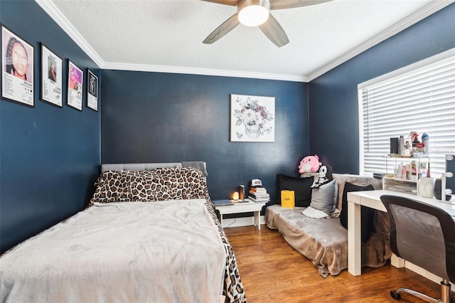 bedroom featuring ceiling fan, ornamental molding, a textured ceiling, and hardwood / wood-style flooring