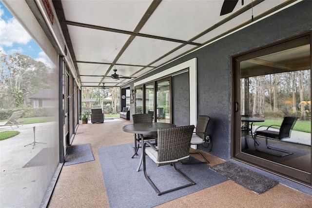 sunroom featuring ceiling fan