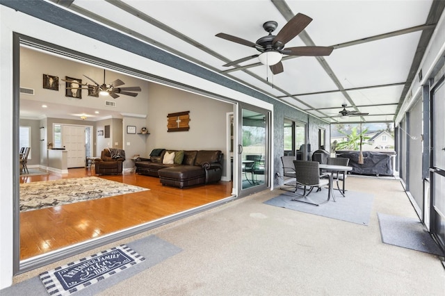 sunroom / solarium featuring ceiling fan