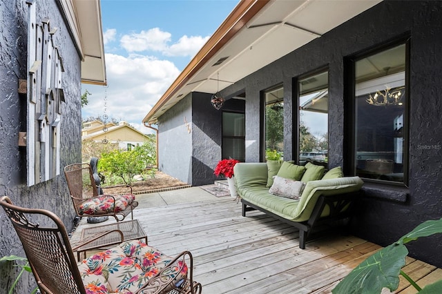 wooden terrace featuring an outdoor hangout area