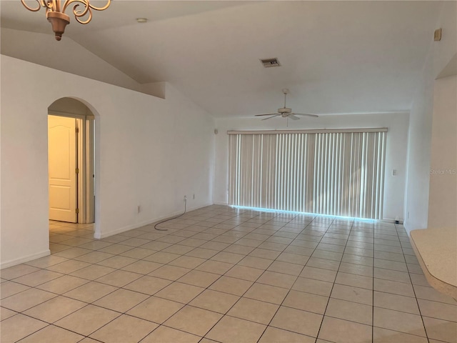 tiled empty room with ceiling fan and lofted ceiling