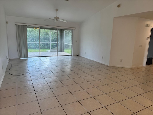 tiled spare room featuring ceiling fan and lofted ceiling