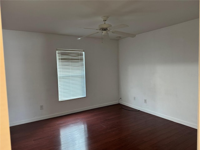 spare room featuring ceiling fan and dark wood-type flooring