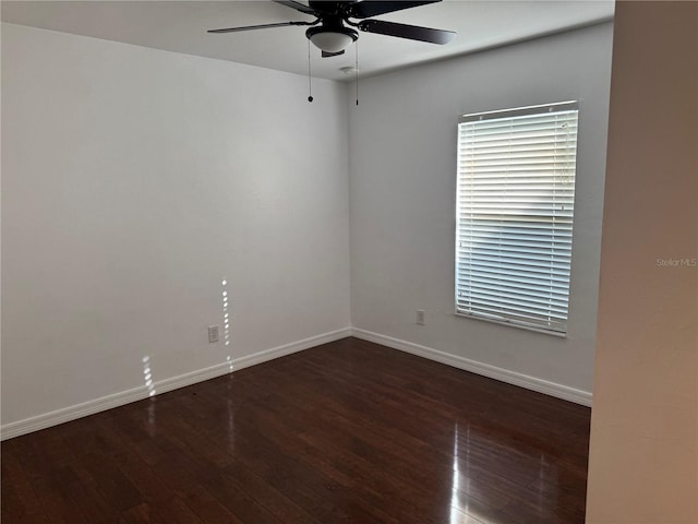 unfurnished room featuring ceiling fan and dark hardwood / wood-style flooring