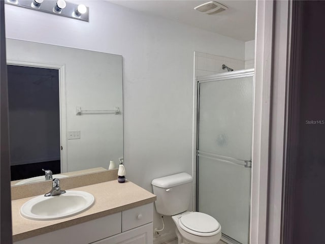 bathroom with toilet, vanity, and walk in shower