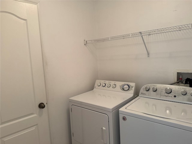 washroom with separate washer and dryer