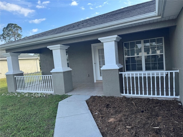 view of exterior entry with covered porch