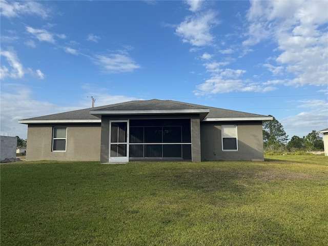 back of house featuring a sunroom and a yard