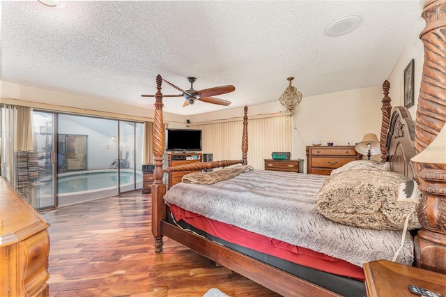 bedroom with access to exterior, dark wood-type flooring, a textured ceiling, and ceiling fan