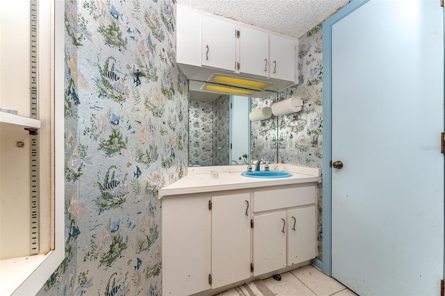 bathroom with vanity, tile patterned floors, and a textured ceiling