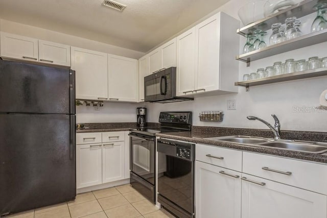 kitchen with sink, white cabinetry, and black appliances