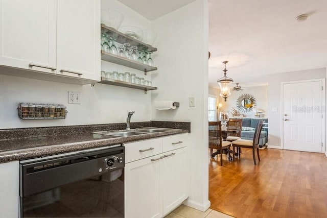 kitchen with white cabinetry, sink, light hardwood / wood-style floors, and black dishwasher