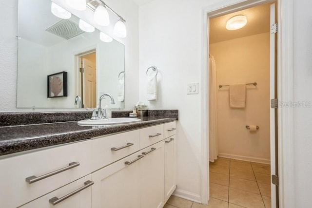 bathroom with tile patterned floors and vanity