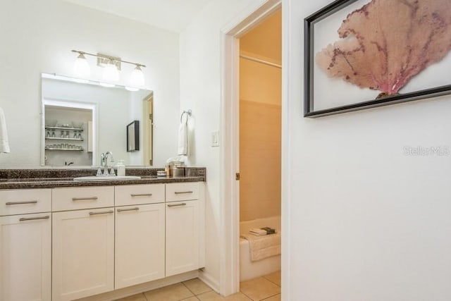 bathroom with tile patterned floors, vanity, and shower / bathtub combination