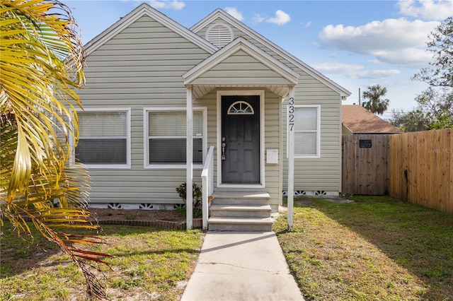 bungalow-style house with a front lawn