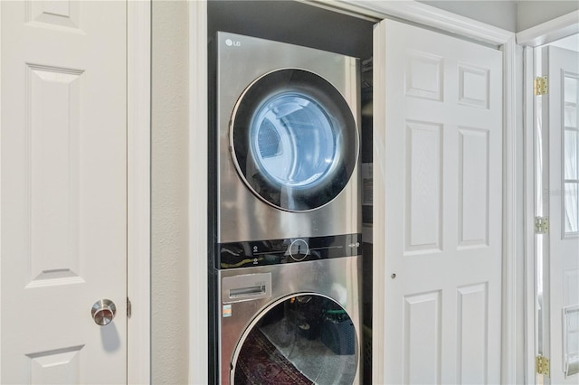 laundry room featuring stacked washer and clothes dryer