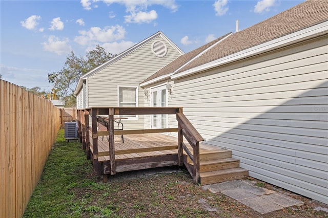 back of house featuring a wooden deck and cooling unit