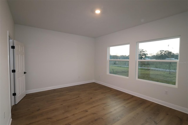 empty room with dark hardwood / wood-style floors